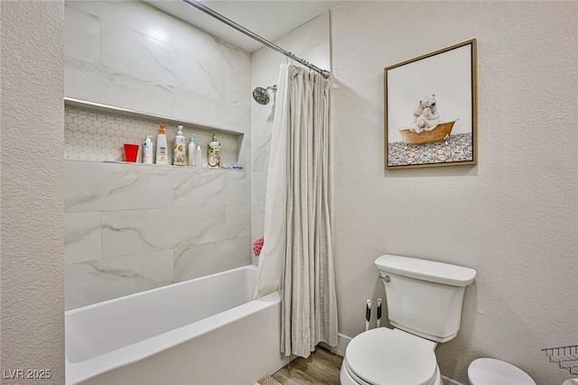 bathroom featuring hardwood / wood-style flooring, toilet, and shower / bath combo with shower curtain