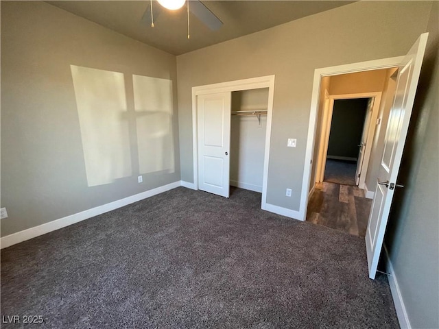 unfurnished bedroom with ceiling fan, a closet, and dark carpet