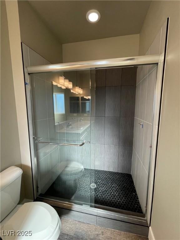 bathroom featuring walk in shower and toilet