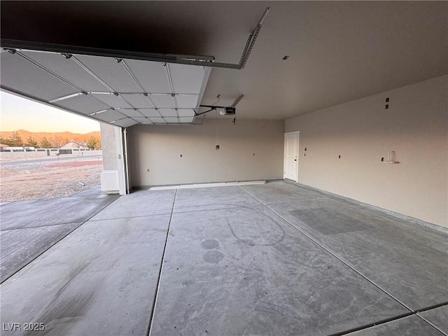 garage at dusk with a garage door opener