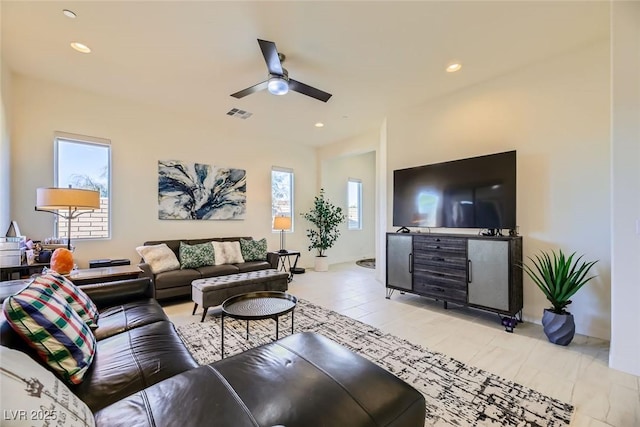 living room featuring ceiling fan and plenty of natural light