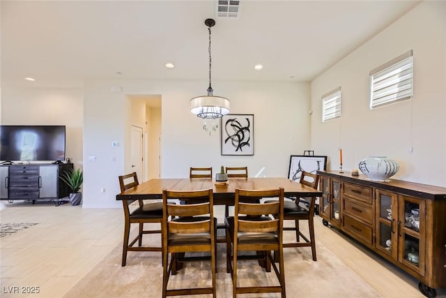 dining space featuring a notable chandelier