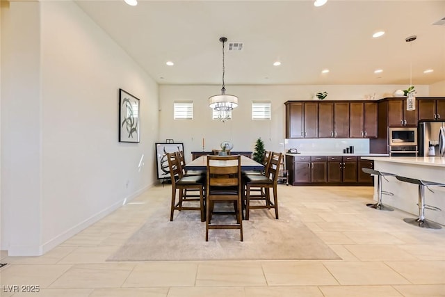 tiled dining space with a notable chandelier