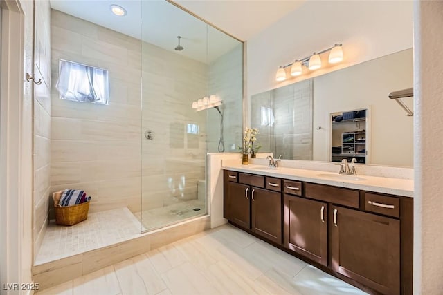 bathroom with vanity, tile patterned floors, and a tile shower