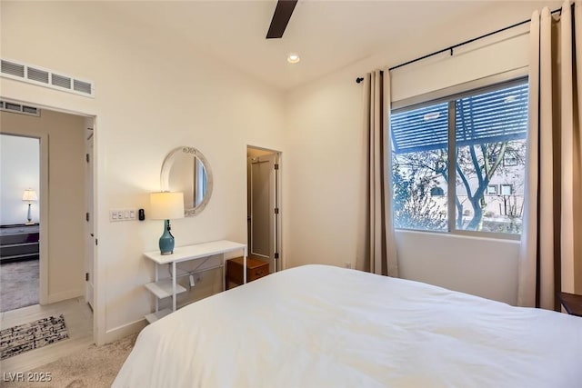 bedroom with ceiling fan and multiple windows