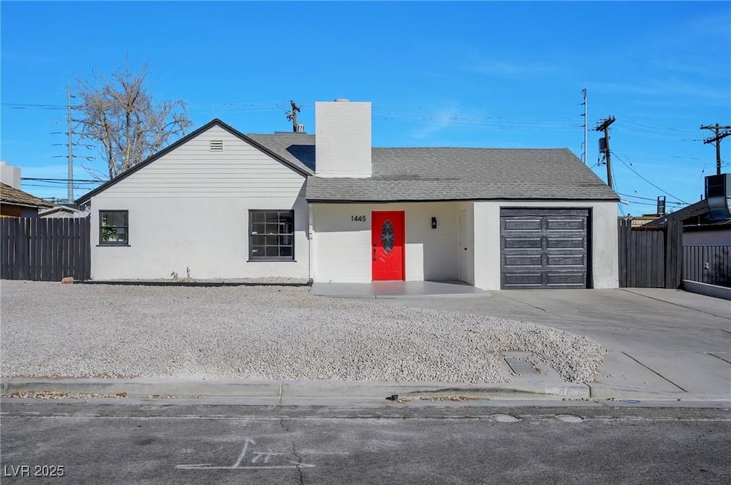 ranch-style home featuring a garage