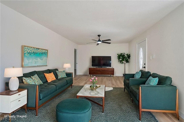 living room featuring ceiling fan and hardwood / wood-style flooring