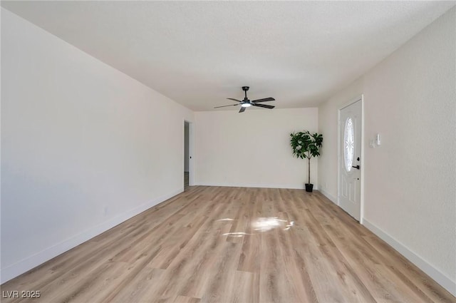 unfurnished room with ceiling fan and light hardwood / wood-style flooring