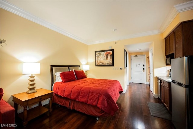 30 Strada Di Villaggio 115, Henderson, NV 89011 - bedroom with baseboards, freestanding refrigerator, ornamental molding, and dark wood-style flooring