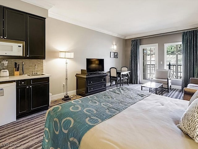 bedroom featuring access to outside, ornamental molding, and sink