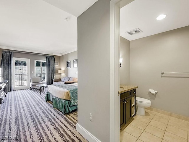 bathroom featuring tile patterned floors, crown molding, vanity, and toilet