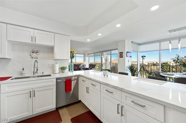 kitchen featuring dishwasher, decorative backsplash, white cabinets, and sink