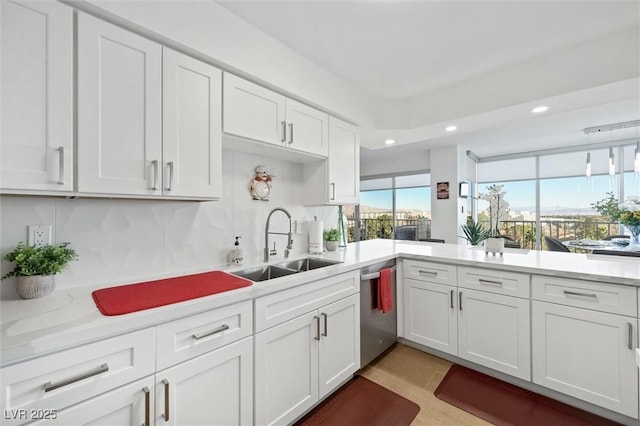 kitchen featuring stainless steel dishwasher, white cabinetry, sink, and light tile patterned floors