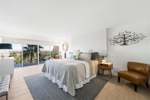 bedroom with access to outside and light wood-type flooring