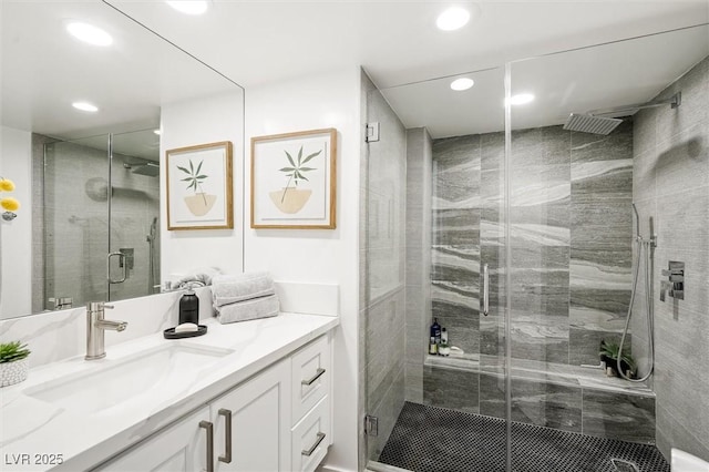 bathroom with vanity and a shower with shower door