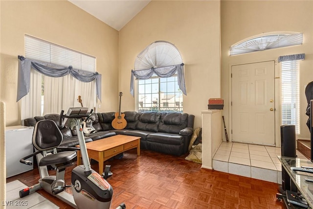 living room featuring high vaulted ceiling and parquet floors