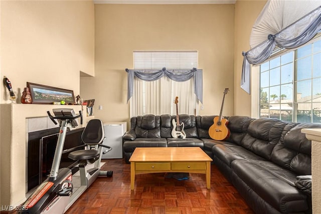 living room with dark parquet floors and a fireplace