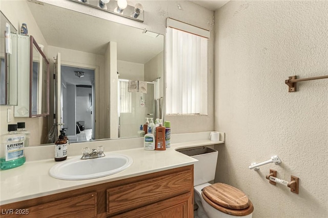 bathroom with vanity, toilet, and walk in shower