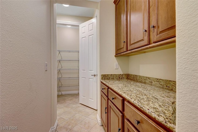 kitchen with light stone countertops and light tile patterned floors