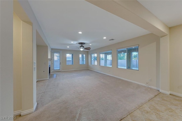 unfurnished room with light colored carpet and ceiling fan