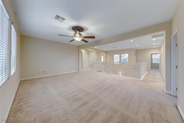 unfurnished living room with ceiling fan and light colored carpet