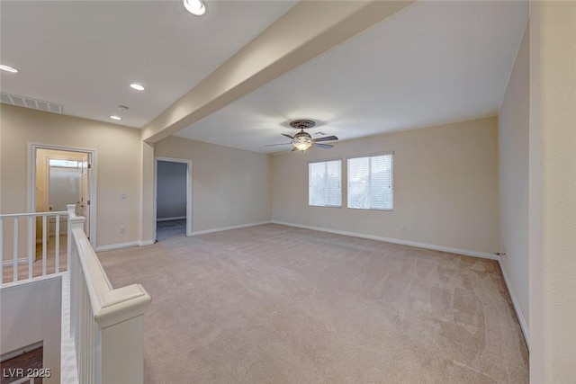 carpeted empty room featuring ceiling fan