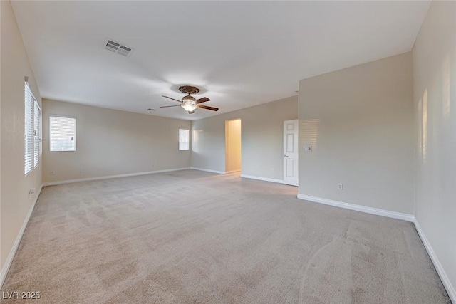 spare room with ceiling fan and light carpet