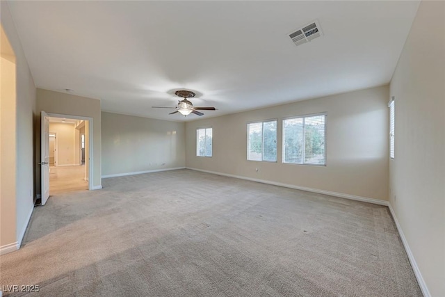 unfurnished room with ceiling fan and light carpet