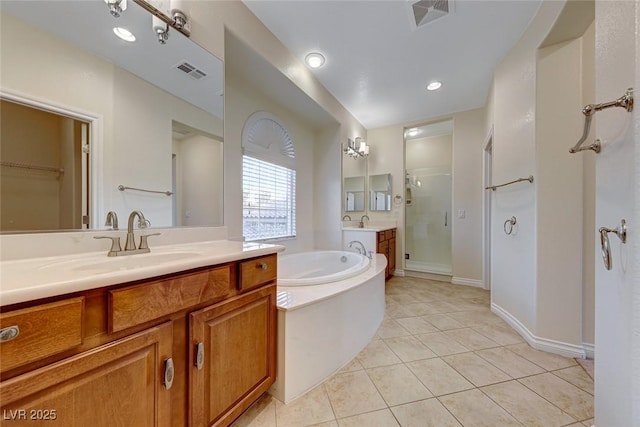 bathroom featuring vanity, tile patterned flooring, and separate shower and tub