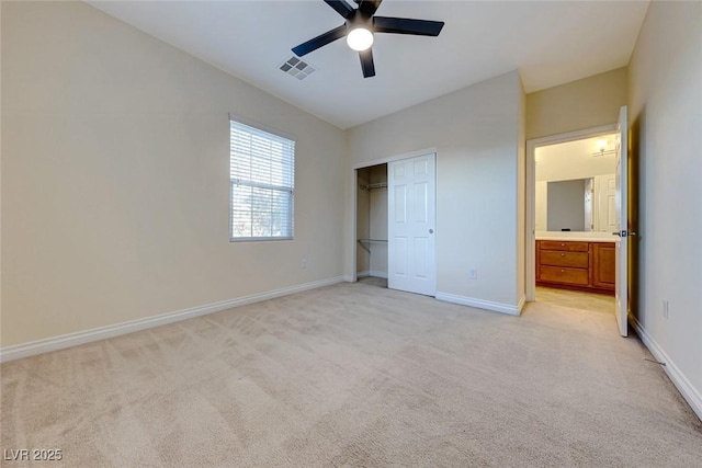 unfurnished bedroom featuring ceiling fan, light colored carpet, and a closet