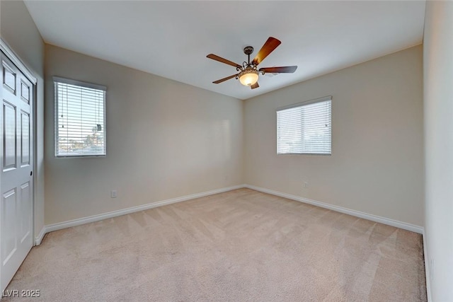 empty room featuring light carpet and ceiling fan