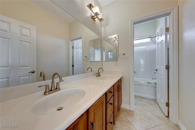 bathroom featuring tile patterned flooring, a tub, and vanity