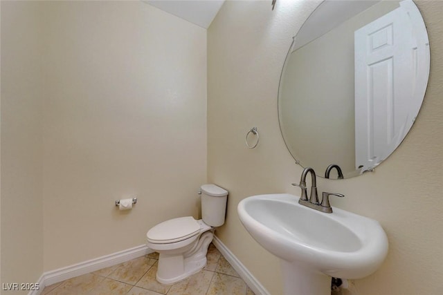 bathroom with sink, tile patterned floors, and toilet