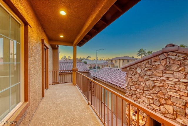 view of balcony at dusk