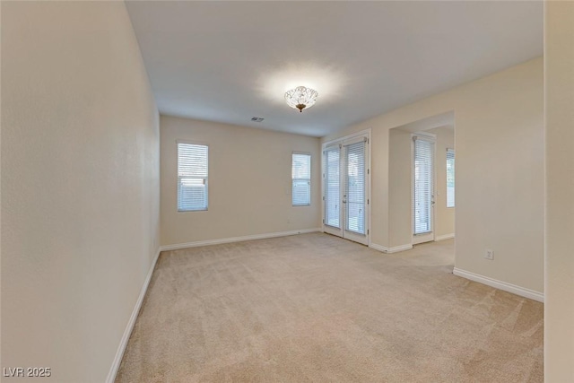 carpeted empty room with french doors