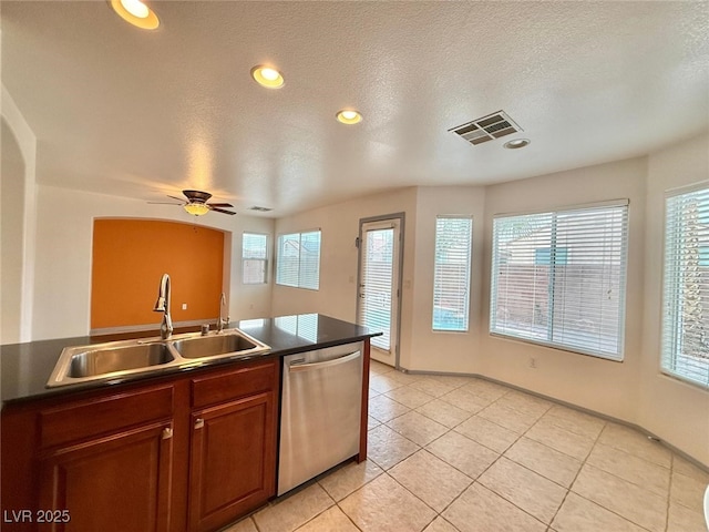 kitchen with a wealth of natural light, stainless steel dishwasher, ceiling fan, and sink