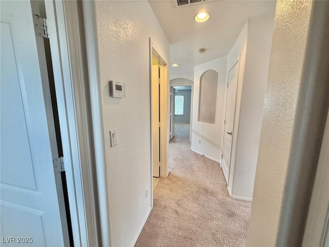 hallway featuring light carpet