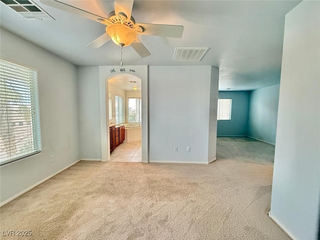 empty room with ceiling fan and light colored carpet