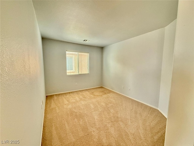 carpeted empty room with a textured ceiling