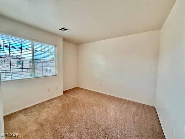 empty room featuring light colored carpet