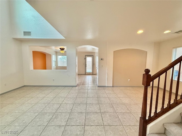 tiled spare room featuring ceiling fan