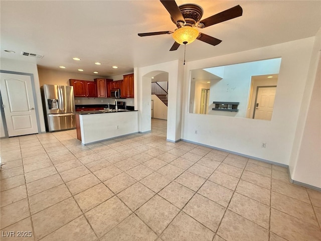 kitchen with ceiling fan, sink, stainless steel appliances, kitchen peninsula, and light tile patterned floors