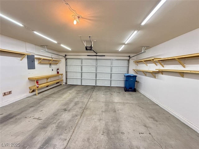 garage with electric panel and a garage door opener