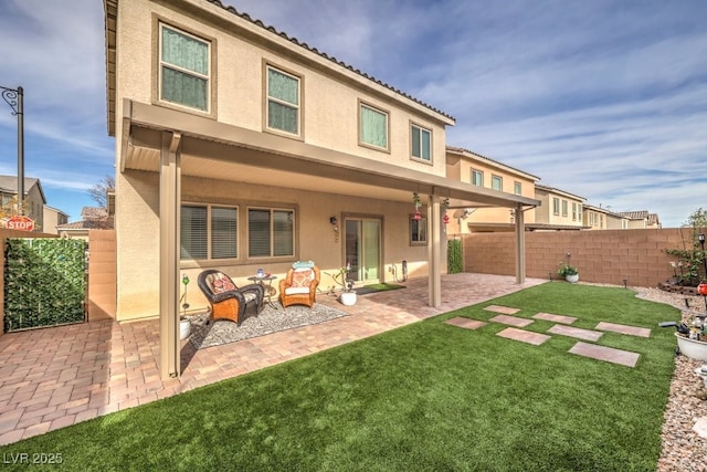 rear view of house featuring a yard, outdoor lounge area, and a patio