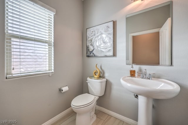 bathroom with wood-type flooring, sink, and toilet