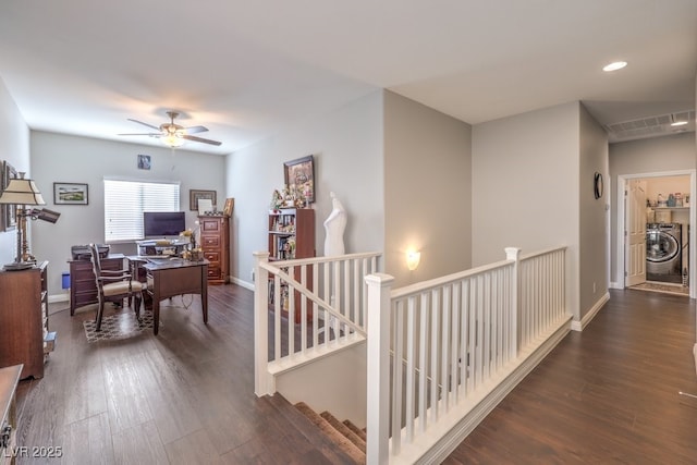 hallway with dark hardwood / wood-style floors and washer / dryer