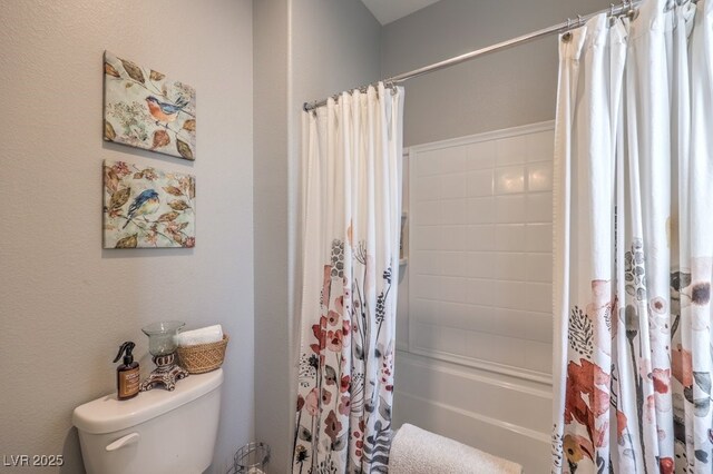 bathroom featuring shower / bath combo and toilet