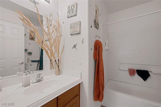 bathroom with tiled shower / bath combo and vanity