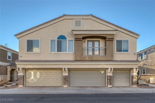 3309 Jamaica Princess Pl Unit 3, North Las Vegas, NV 89084 - townhome / multi-family property with a garage, stucco siding, and stone siding