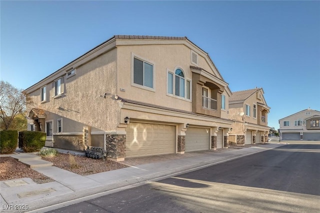 3309 Jamaica Princess Pl Unit 3, North Las Vegas, NV 89084 - view of building exterior featuring an attached garage and driveway